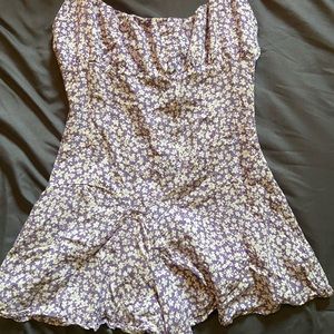 Lilac romper with white flowers, ruffle bottom